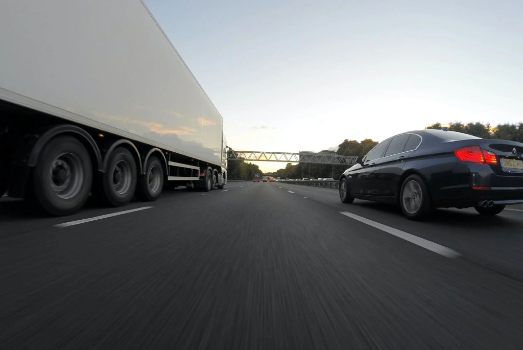 a semi truck and a car on a highway